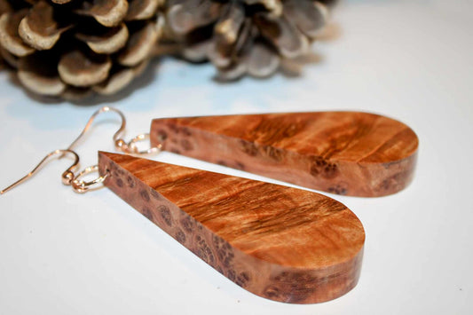Handmade wooden earrings with polished thuya burr wood in a teardrop shape with rose gold or sterling silver shepherd hypoallergenic hooks